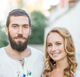 Couple posing for a photo outdoors man with a beard and light shirt and a smiling blonde woman beside him   Nerds On Site